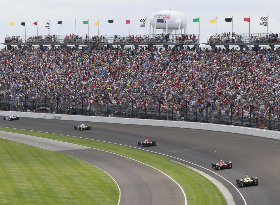 FILE - Fans watch the running of the Indianapolis 500 auto race in the first turn at Indianapolis Motor Speedway in Indianapolis, in this Sunday, May 28, 2017, file photo. The Indianapolis 500 will be the largest sporting event since the start of the pandemic with 135,000 spectators permitted to attend “The Greatest Spectacle in Racing” next month. Indianapolis Motor Speedway said Wednesday, April 21, 2021, it worked with the Marion County Public Health Department to determine 40% of venue capacity can attend the May 30 race. (AP Photo/R Brent Smith, File)