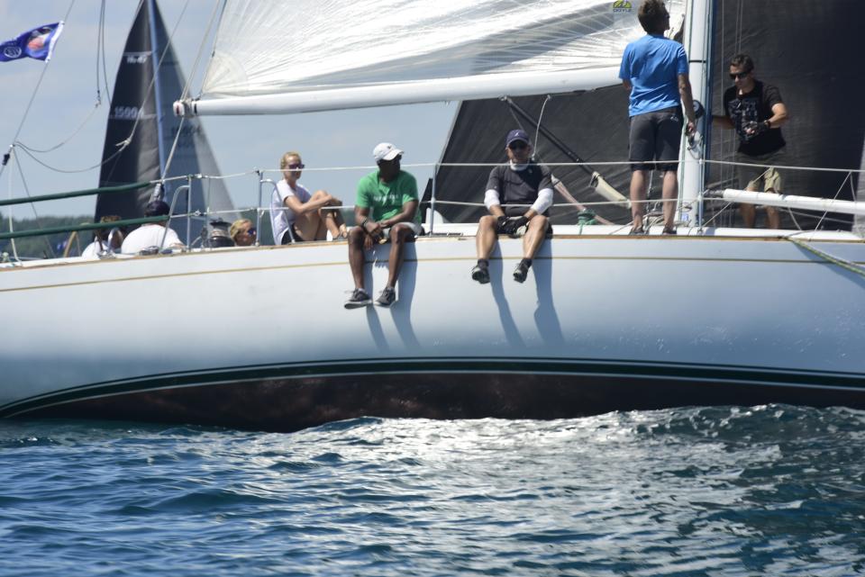 Crew members from Velero VII sit on the edge of the boat during the start of the Bayview Mackinac Race in Port Huron on Saturday, July 16, 2022.