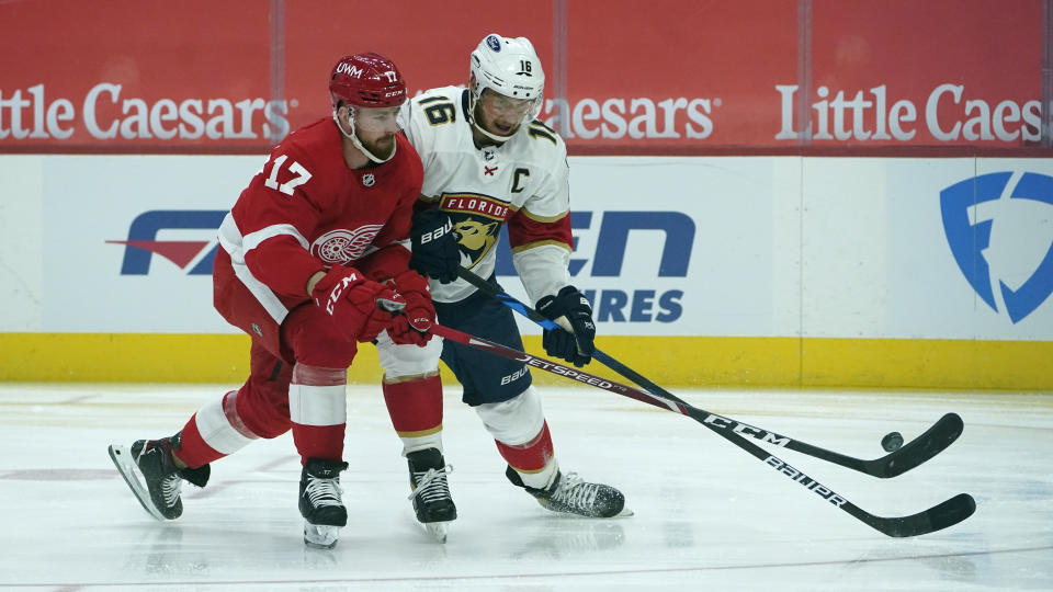 Detroit Red Wings defenseman Filip Hronek (17) defends Florida Panthers center Aleksander Barkov (16) in the first period of an NHL hockey game Sunday, Jan. 31, 2021, in Detroit. (AP Photo/Paul Sancya)