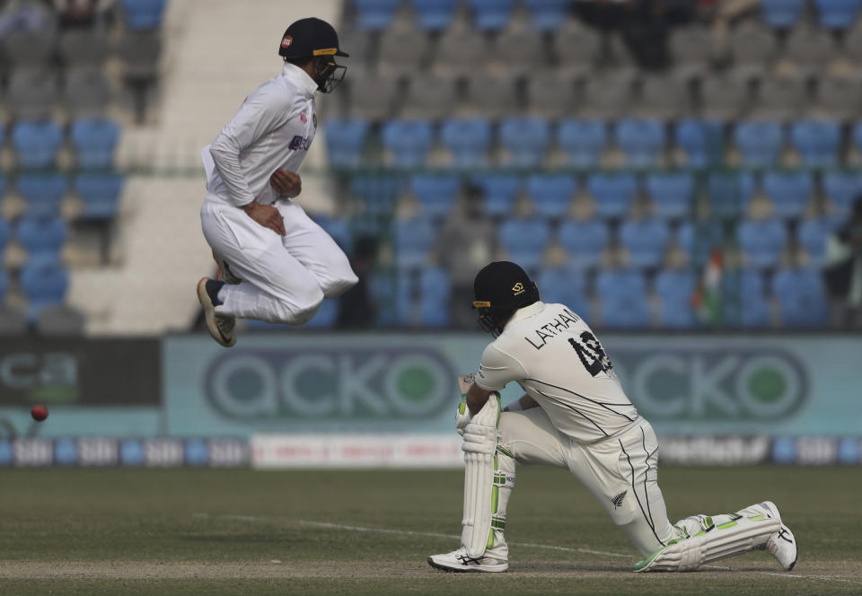 India's Shubman Gill jumps in air to avoid getting hit by New Zealand's Tom Latham's shot during the day two of their first test cricket match in Kanpur, India, Friday, Nov. 26, 2021. (AP Photo/Altaf Qadri)