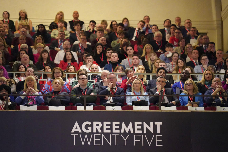 Participants attend the first day of a three-day international conference at Queen's University Belfast to mark the 25th anniversary of the Good Friday Agreement, in Belfast, Northern Ireland, Monday, April 17, 2023. Former U.S. President Bill Clinton and past leaders of the U.K. and Ireland are gathering in Belfast on Monday, 25 years after their charm, clout and determination helped Northern Ireland strike a historic peace accord. (Niall Carson/PA via AP)