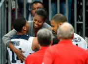 LONDON, ENGLAND - JULY 29: First Lady Michelle Obama of the United States hugs Anthony Davis #14 of United States after winning their the Men's Basketball game against France on Day 2 of the London 2012 Olympic Games at the Basketball Arena on July 29, 2012 in London, England. (Photo by Pascal Le Segretain/Getty Images)