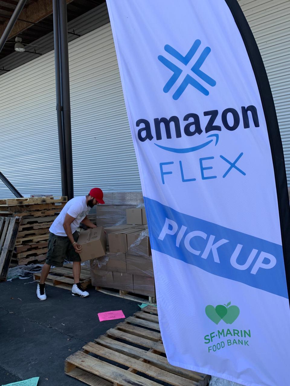 An Amazon Flex driver loads boxes of food at the San Francisco-Marin Food Bank. The company has partnered with food banks nationally to provide free delivery of food to people who must shelter in place during the COVID-19 emergency.