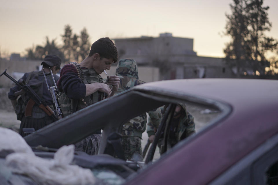 U.S.-backed Syrian Democratic Forces (SDF) prepare to head to the front line outside Baghouz, Syria, where Islamic State militants hold a small piece of territory, Sunday, March 10, 2019. U.S.-backed Syrian fighters resumed their offensive on the last pocket held by the Islamic State group in eastern Syria on Sunday lighting the skies over the besieged village as artillery shelling and heavy gunfire rang in the distance. (AP o/Maya Alleruzzo)