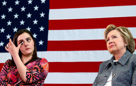 Erica Smegielski (L) wipes a tear as U.S. Democratic presidential candidate Hillary Clinton leads a discussion on gun violence prevention with family members of victims at the Wilson-Gray YMCA in Hartford, Connecticut, U.S., April 21, 2016. REUTERS/Adrees Latif