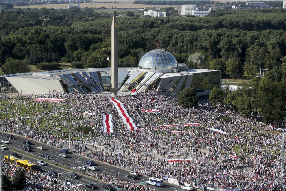 FILE - In this file photo taken on Sunday, Aug. 16, 2020, Belarusian opposition supporters rally in the center of Minsk, Belarus. When unprecedented crowds of 200,000 people marched through Minsk's tidy, broad avenues Sunday, they came to a halt at red traffic lights, waiting obediently until they turned green. A former Soviet republic on the fault line between Russia and Europe is boiling with revolt this summer. Sounds familiar — but Belarus 2020 isn’t Ukraine 2014, and that’s why it’s hard to predict what will happen next. (AP Photo/Dmitri Lovetsky, File)