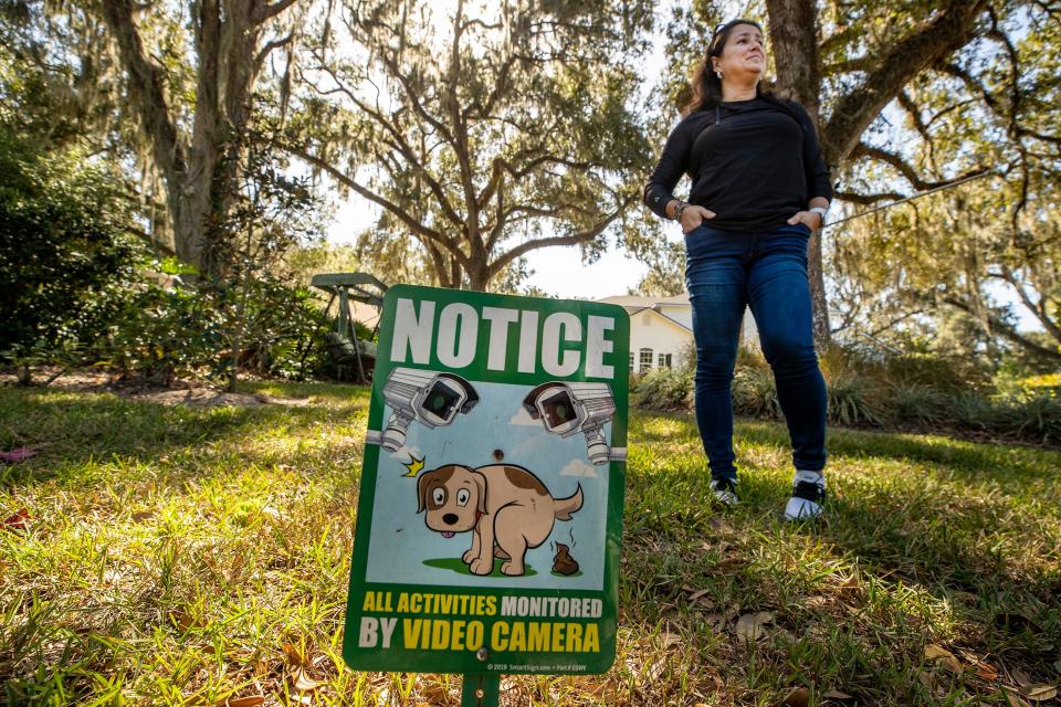 Alyne Aca has installed video monitoring in front of her home in the Longwood Oaks neighborhood in South Lakeland. While the HOA's board of directors is pursuing a lawsuit against her over the construction of a carport, she says she has faced harassment from board members and other residents.