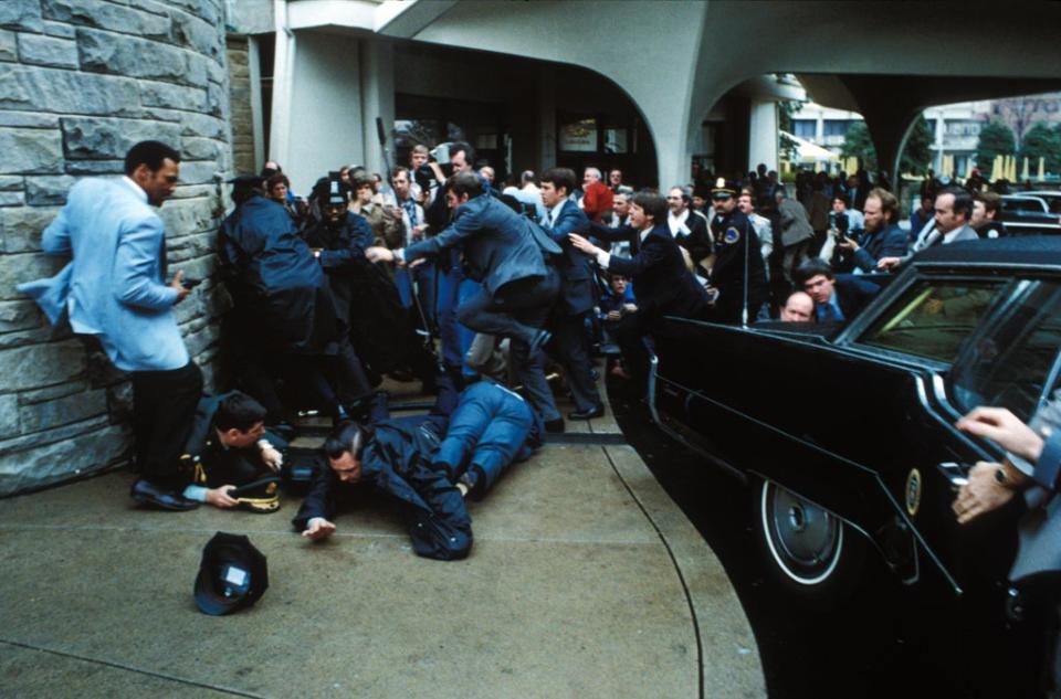 Secret Service agents pounce on John Hinckley Jnr while Press Secretary James Brady, Patrolman Thomas Delahanty and Secret Service Agent Timothy Mccarty lie injured on the ground (Zuma/Shutterstock)