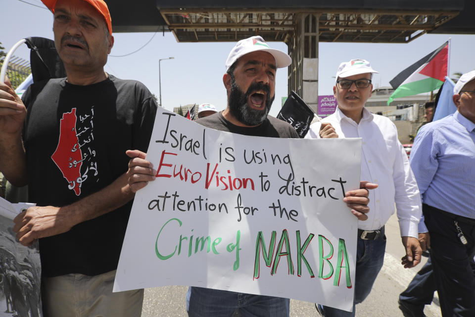 A man holds anti-Eurovision banner as Palestinian marked the 71st anniversary of their mass displacement during the 1948 war around Israel's creation. Demonstrations were held across the Israeli-occupied West Bank and the Gaza Strip on Wednesday to mark what the Palestinians call the "nakba," or "catastrophe." (AP Photo/Mahmoud Illean)