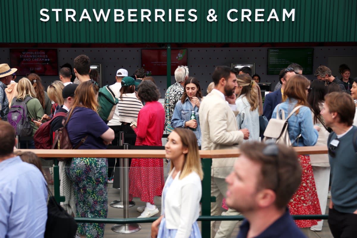 The queue for strawberries and cream, whose price has been frozen for a 13th year (Getty)