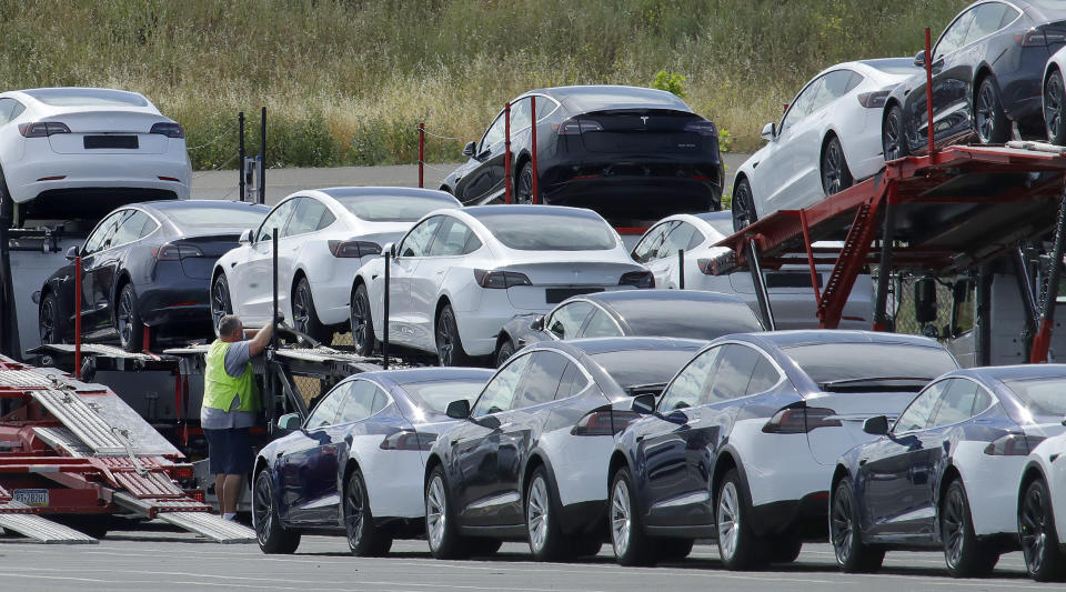 FILE - Tesla cars are loaded onto carriers at the Tesla electric car plant on May 13, 2020, in Fremont, Calif. Tesla is recalling nearly 363,000 vehicles with its “Full Self-Driving” system to fix problems with the way it behaves around intersections and following posted speed limits, the National Highway Traffic Safety Administration announced Thursday, Feb. 16, 2023. (AP Photo/Ben Margot, File)