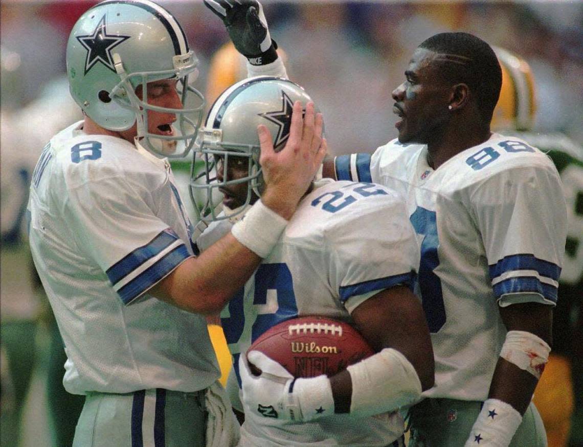 Former Dallas Cowboys stars Troy Aikman, Emmitt Smith and Michael Irvin celebrate a touchdown in the NFC championship game on Jan. 14, 1996. The Cowboys won three Super Bowls in four seasons with the trio but also suffered bad losses in each of those championship seasons.