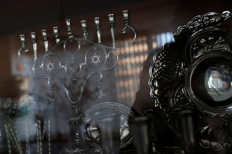 A menorah and other Hebrew items sit in a cabinet at Lea and Yehuda Evron's apartment in the Queens borough of New York