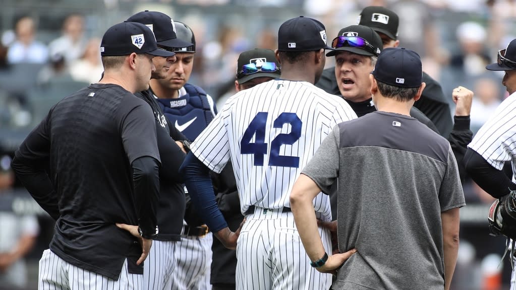 Apr 15, 2023; Bronx, New York, USA; New York Yankees starting pitcher Domingo German is checked by the umpire for illegal substances on his hand in the fourth inning against the Minnesota Twins at Yankee Stadium.