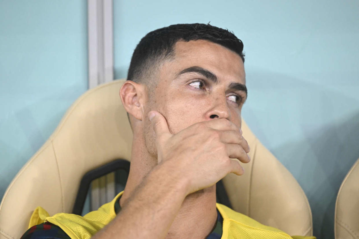 Portugal's forward #07 Cristiano Ronaldo sits on the bench during the Qatar 2022 World Cup round of 16 football match between Portugal and Switzerland at Lusail Stadium in Lusail, north of Doha on December 6, 2022. (Photo by PATRICIA DE MELO MOREIRA / AFP)