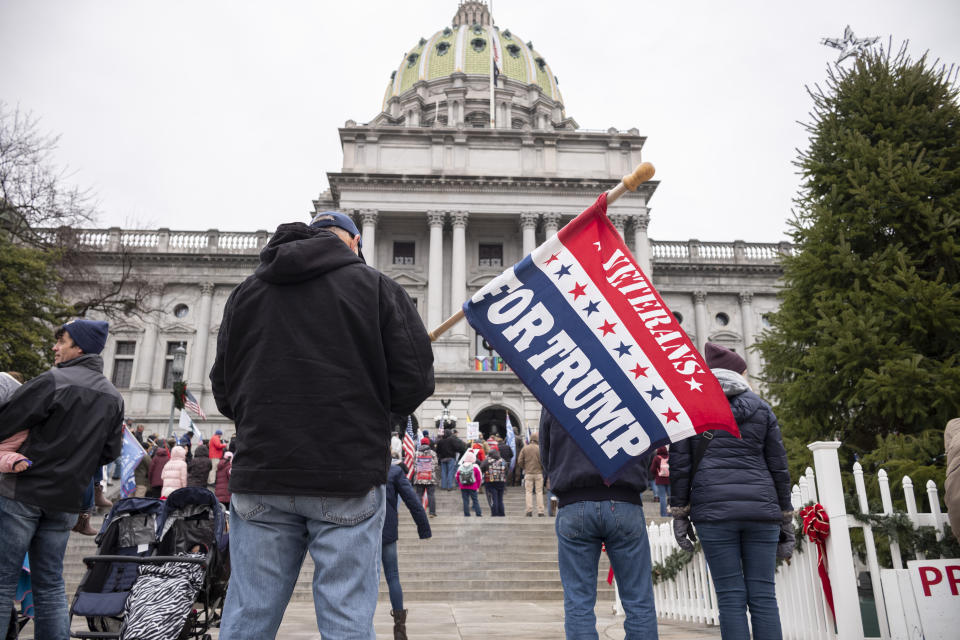 President Donald Trump supporters gather on the statehouse steps as the Pennsylvania House of Representatives are sworn-in, Tuesday, Jan. 5, 2021, at the state Capitol in Harrisburg, Pa. The ceremony marks the convening of the 2021-2022 legislative session of the General Assembly of Pennsylvania. (AP Photo/Laurence Kesterson)