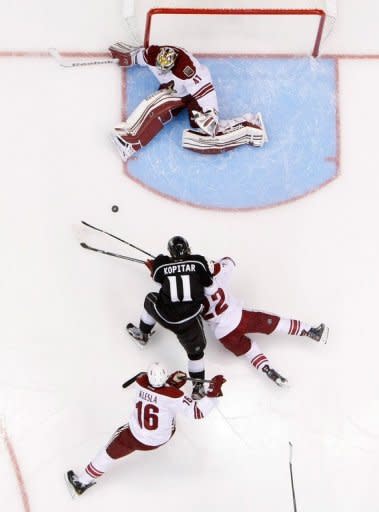 Anze Kopitar (C) of the Los Angeles Kings attempts to score on goaltender Mike Smith (top) of the Phoenix Coyotes during the 2012 NHL Stanley Cup Playoffs at Staples Center in Los Angeles, California. Smith posted this third shutout of the post-season as the Phoenix Coyotes staved off elimination from the Stanley Cup playoffs by beating Los Angeles 2-0