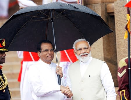 India's Prime Minister Narendra Modi shakes hands with Sri Lanka's President Maithripala Sirisena during his welcome ceremony at the Presidential Secretariat in Colombo