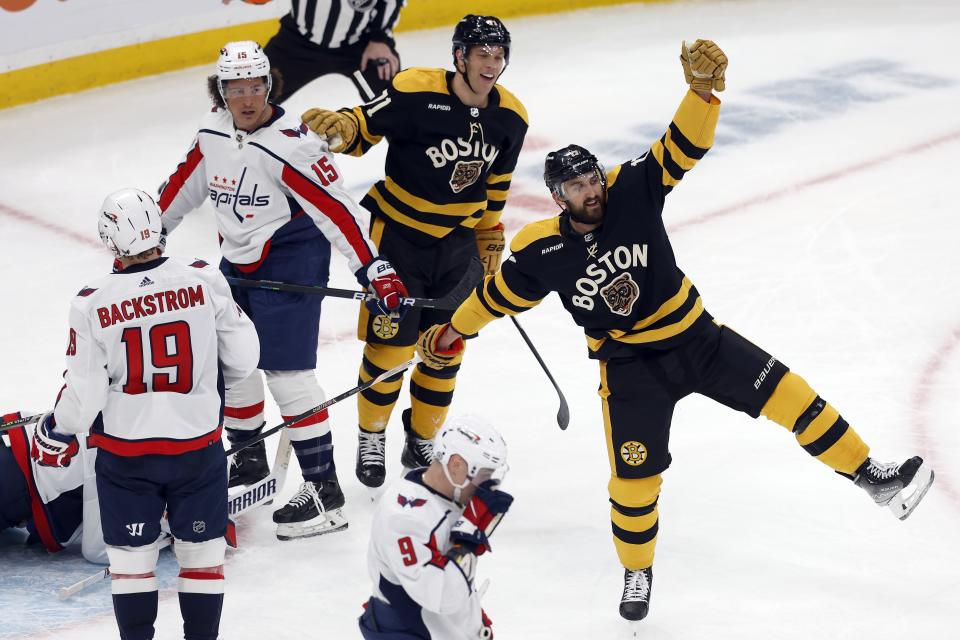 Boston Bruins' Nick Foligno (17) celebrates his goal as Washington Capitals' Sonny Milano (15) looks on during the second period of an NHL hockey game, Saturday, Feb. 11, 2023, in Boston. (AP Photo/Michael Dwyer)