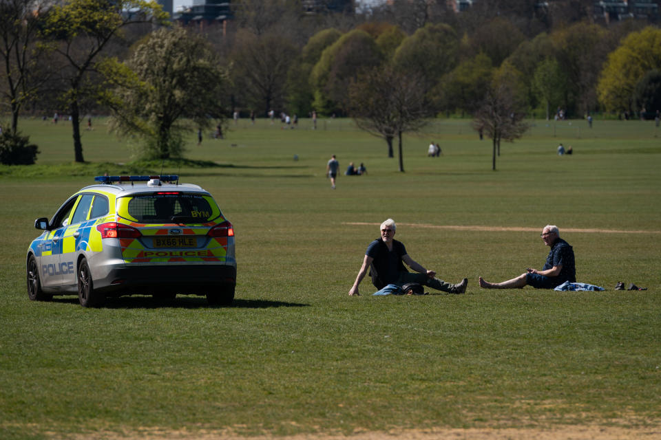 Police move on sunbathers in Regents Park, London, as the UK continues in lockdown to help curb the spread of the coronavirus.