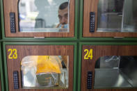 A ready to take away Go Noodles box is placed in a glass-paned locker in Tel Aviv, Israel, Thursday, July 16, 2020. The coronavirus crisis and its economic impact have forced many small businesses and restaurants to shut their doors in recent months, but Tel Aviv's Go Noodles opened a new branch last week that features digital-only ordering and pickup from lockers. (AP Photo/Ariel Schalit)