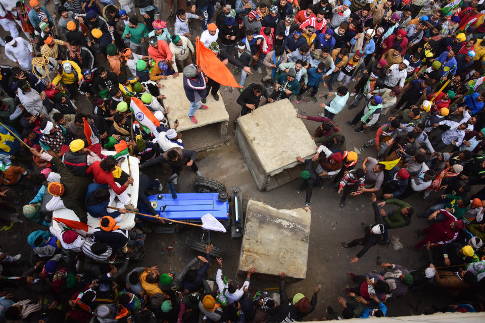 Protesters remove police barricades from the road during the...