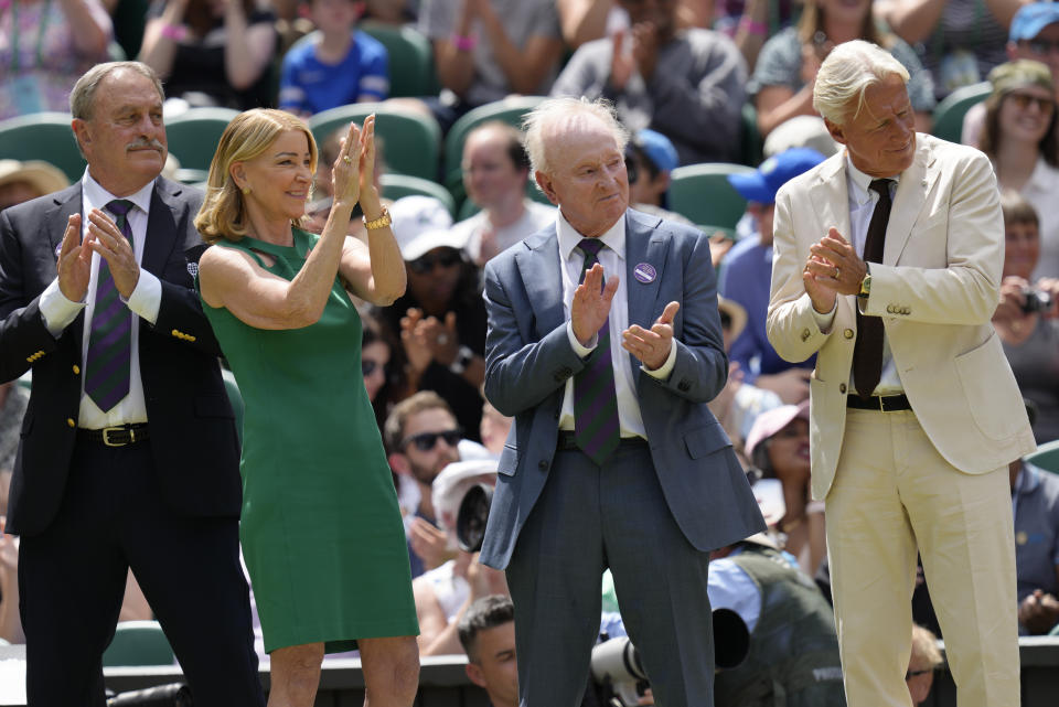 Former Wimbledon singles champions from left: John Newcombe, Chris Evert, Rod Laver and Bjorn Borg applaud during a 100 years of Centre Court celebration on day seven of the Wimbledon tennis championships in London, Sunday, July 3, 2022. (AP Photo/Kirsty Wigglesworth)