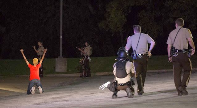 Police officers briefly detain a person in Ferguson, Missouri. Photo: AP.