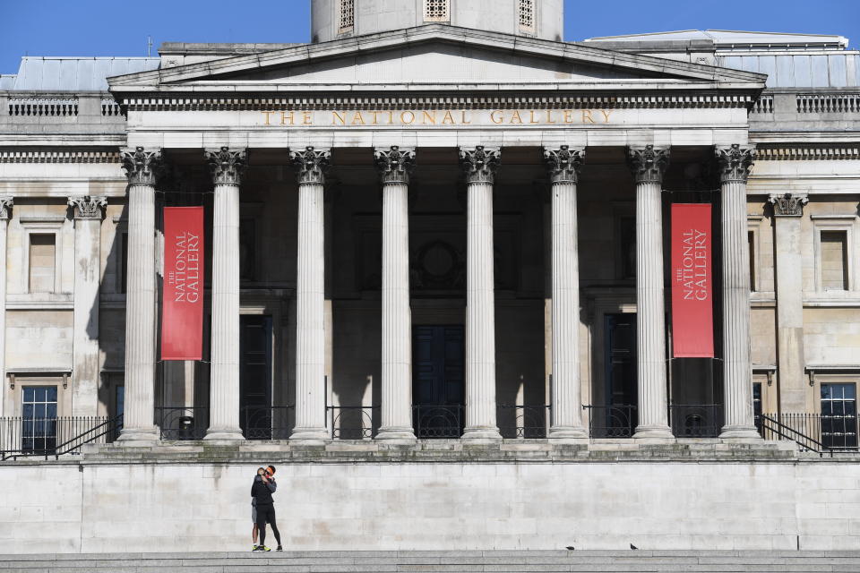 A couple hug on the steps on The National Gallery in Trafalgar Square in London the day after Prime Minister Boris Johnson put the UK in lockdown to help curb the spread of the coronavirus.