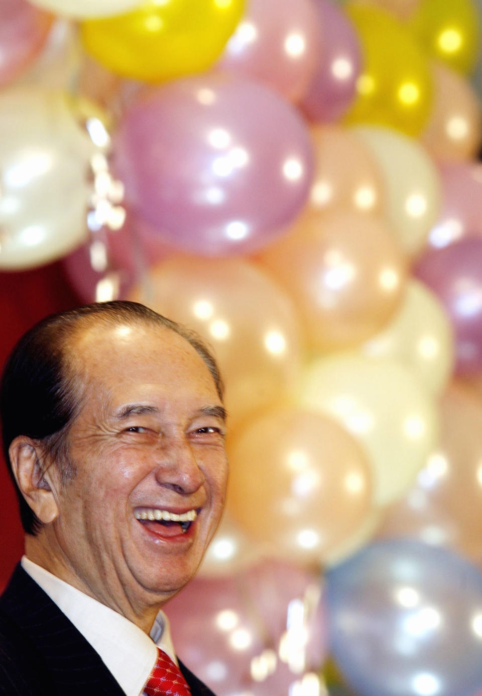 FILE - In this Nov. 20, 2006, file photo, Macau tycoon Stanley Ho smiles during a party to celebrate his 85-year-old birthday in Hong Kong. On Tuesday, May 26, 2020, the family of Stanley Ho, the Macao casino tycoon considered the father of modern gambling in China, has died at 98. (AP Photo/Vincent Yu, File)