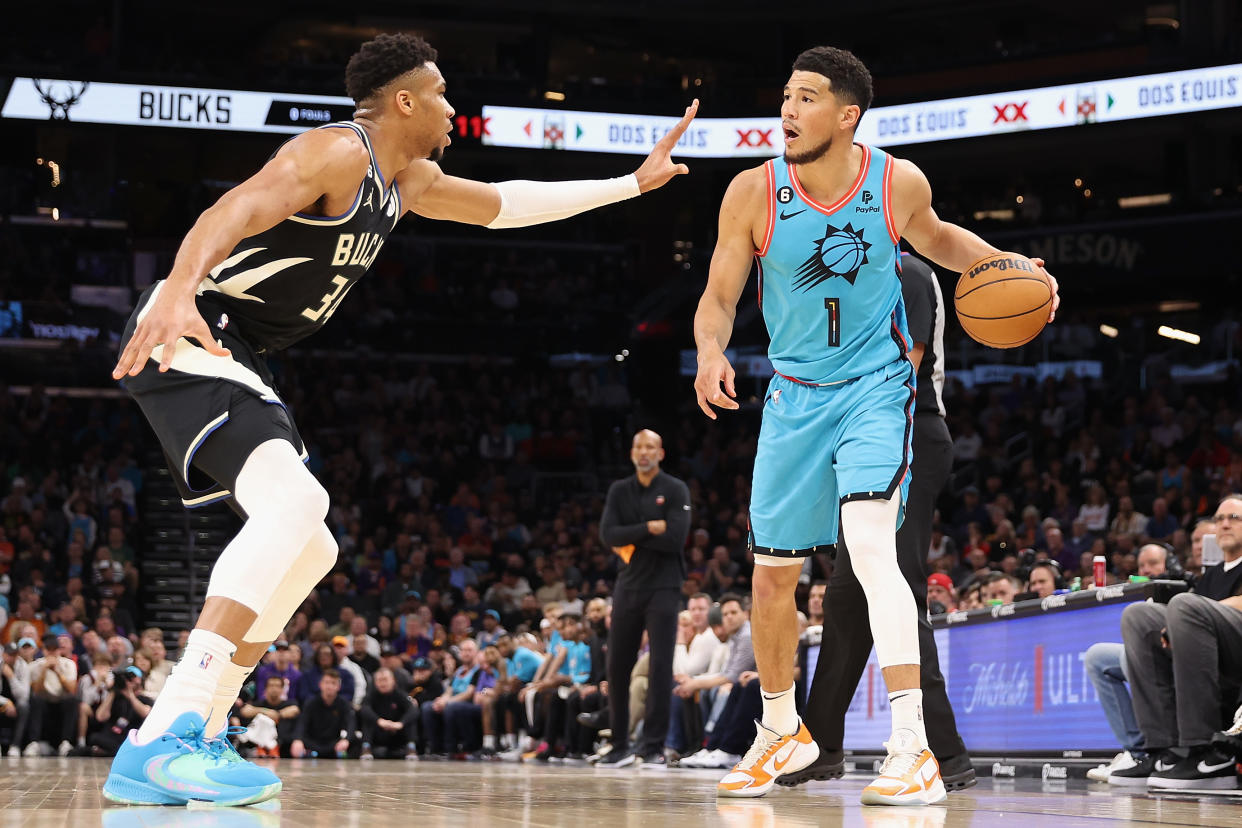 Phoenix Suns guard Devin Booker handles the ball against Milwaukee Bucks forward Giannis Antetokounmpo during a regular season game on March 14, 2023 at Footprint Center in Phoenix. (Christian Petersen/Getty Images)