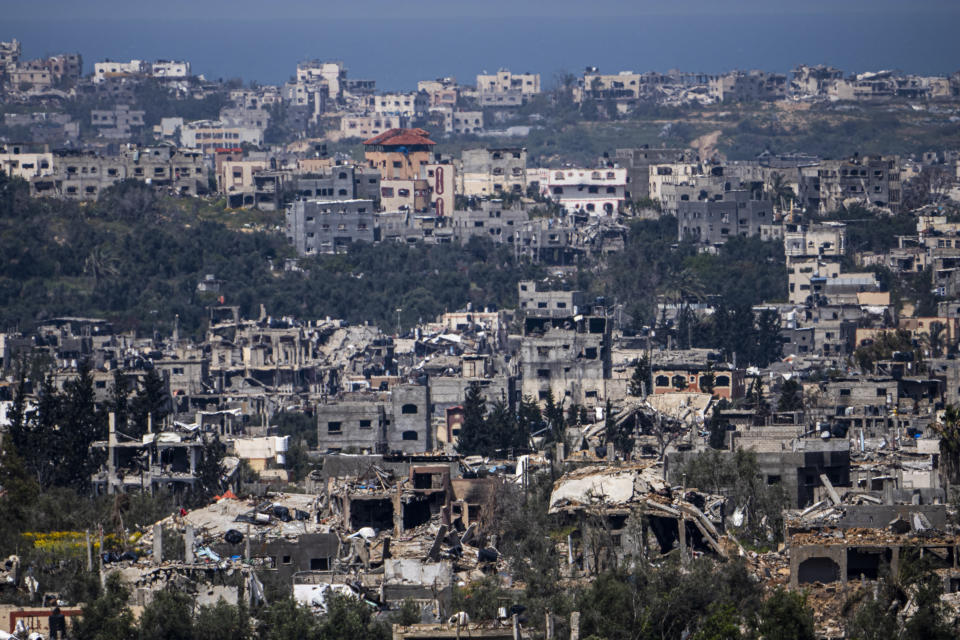 Destroyed buildings stand inside the Gaza Strip, as seen from southern Israel, Tuesday, March 26, 2024. (AP Photo/Ariel Schalit)