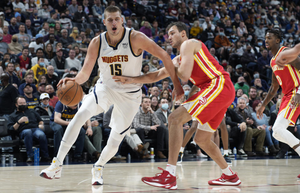 Denver Nuggets center Nikola Jokic, left, drives past Atlanta Hawks forward Danilo Gallinari during the second half of an NBA basketball game Friday, Nov. 12, 2021, in Denver. The Nuggets won 105-96. (AP Photo/David Zalubowski)