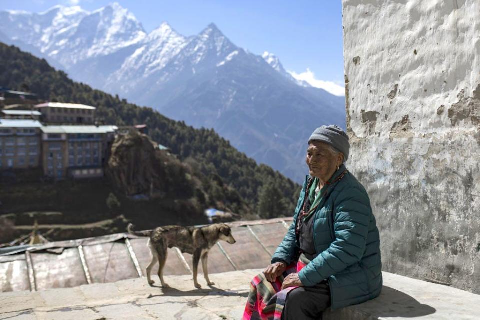 An old sherpa woman in front of her house at Namche Bazar in Lukla, Nepal.