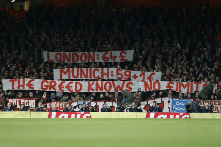 Bayern Munich fans raise banners to complain about the cost of match day tickets during the Champions League last 16 second leg against Arsenal at The Emirates Stadium in London on March 7, 2017