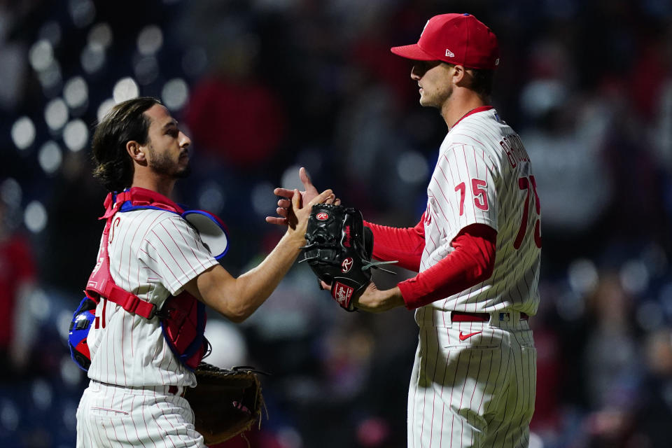 Philadelphia Phillies catcher Garrett Stubbs, left, and pitcher Connor Brogdon react after a baseball game against the Atlanta Braves, Friday, Sept. 23, 2022, in Philadelphia. (AP Photo/Matt Slocum)