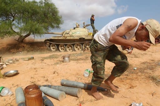 A Libyan National Transitional Council (NTC) tank shells the city of Sirte. Libya's new rulers on Thursday stepped up the hunt for Moamer Kadhafi's inner circle, seeking the arrest of one of his sons, Saadi, and announcing the capture of his spokesman Mussa Ibrahim