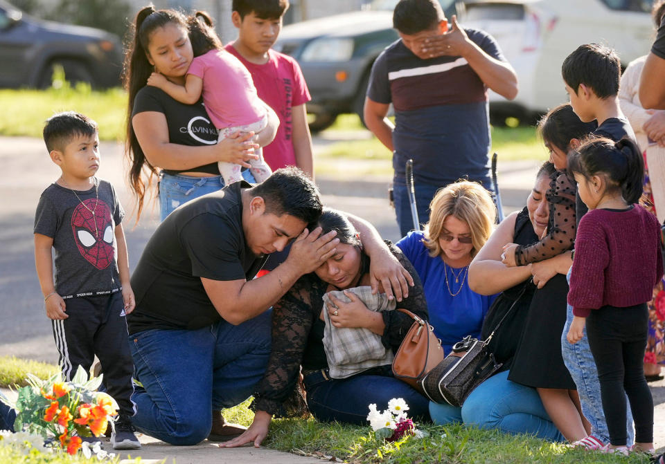 A woman is consoled at the site where her husband was killed in Austin. (Jay Janner / USA-Today Network)