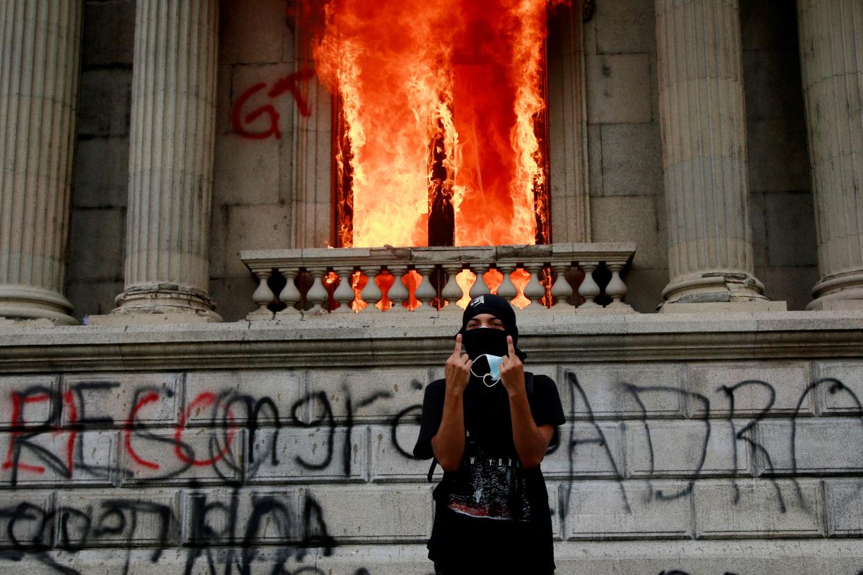 <p>Flames poured out of the windows of the legislative building in Guatemala City yesterday afternoon.</p> (Associated Press)