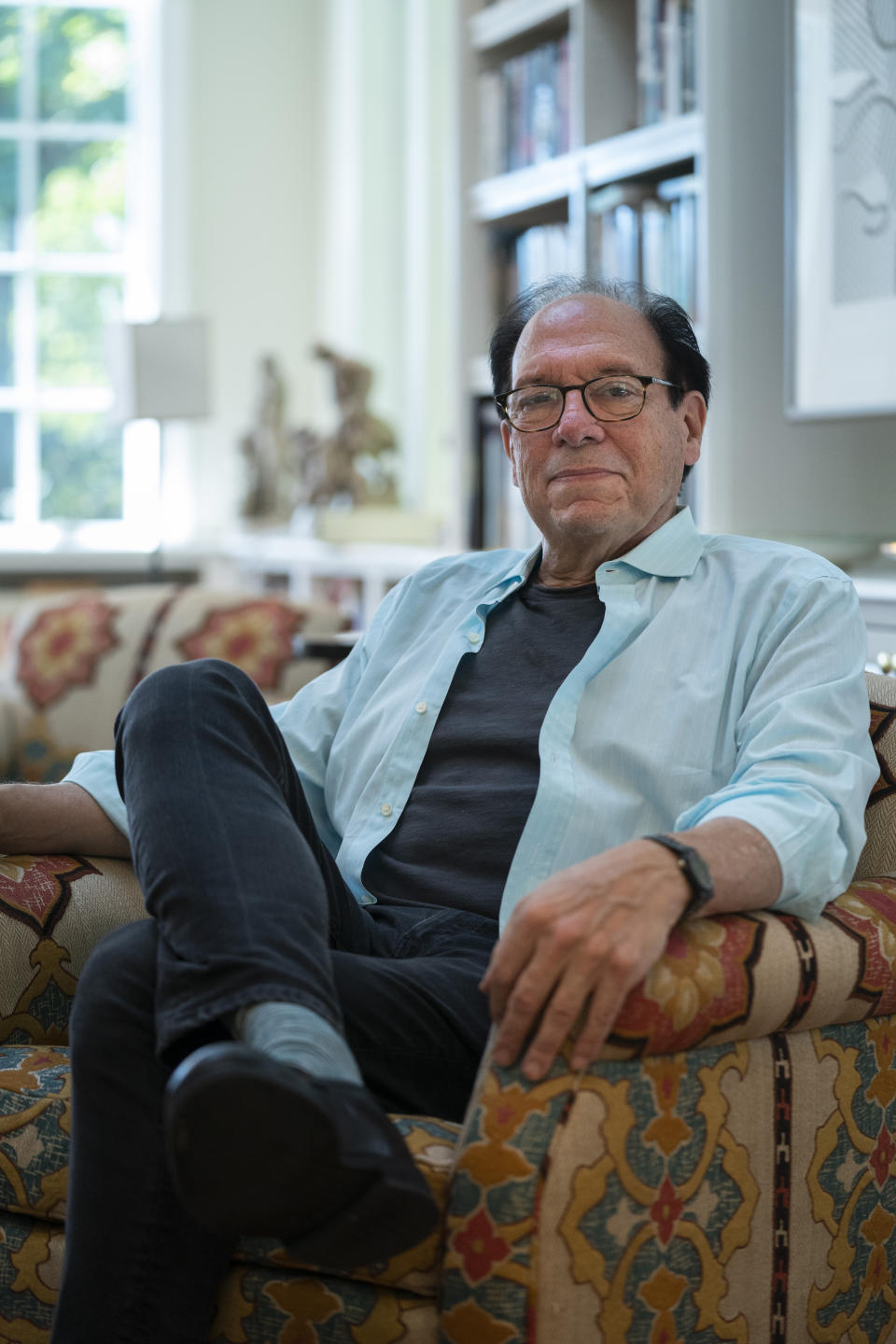 Playwright Ken Ludwig poses for a portrait in his home, Friday, Aug. 12, 2022, in Washington. Ludwig has revisited one of his most beloved plays and flipped the characters’ genders. “Lend Me a Soprano” inverts Ludwig’s madcap screwball comedy “Lend Me a Tenor” by having ladies take the lead three parts, a change he initiated so that a whole new raft of comedians could shine. “Lend Me a Soprano” makes its world premiere this fall at the Ally Theatre in Houston on Sept. 16. (AP Photo/Evan Vucci)