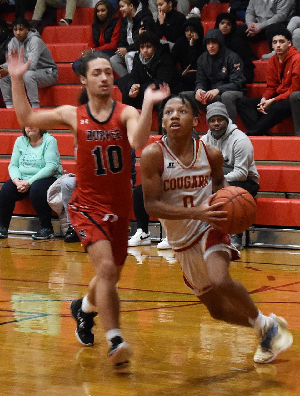 Bishop Connolly's Jah Stephenson drives to the basket on Durfee's Avonte Lamore.