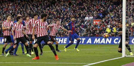 Football Soccer - Barcelona v Athletic Bilbao - Spanish La Liga Santander - Camp Nou stadium, Barcelona, Spain, 04/02/17 Athletic Bilbao's goalkeeper Gorka Iraizoz (R) fails to stop a shot from Barcelona's Lionel Messi (unseen) to score a goal. REUTERS/Albert Gea