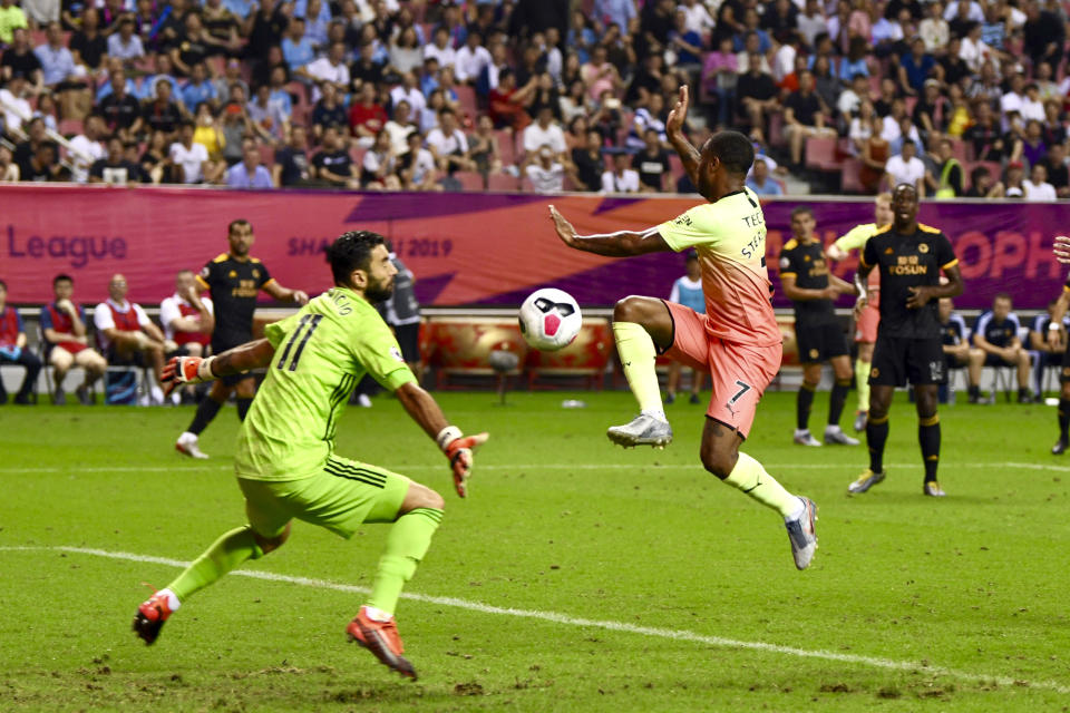 Wolverhampton Wanderers's goalkeeper Rui Patricio, left, blocks an attempt by Raheem Sterling of Manchester City in the final of the Premier League Asia Trophy in Shanghai, China, Saturday, July 20, 2019. Wolverhampton Wanderers beat the Manchester City in the final by 3-2 in the penalty shoot-out. (Chinatopix Via AP) CHINA OUT