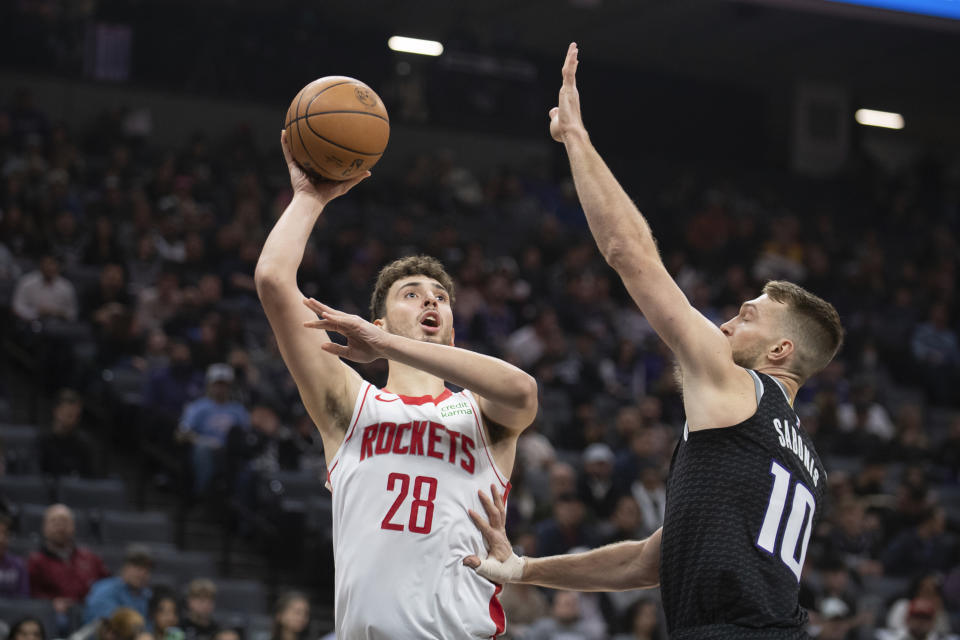 Houston Rockets center Alperen Sengun (28) scores over Sacramento Kings forward Domantas Sabonis (10) during the first half of an NBA basketball game in Sacramento, Calif., Friday, Jan. 13, 2023. (AP Photo/José Luis Villegas)