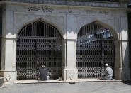 Kashmiri Muslims pray outside the closed gate of a muslim shrine during the holy fasting month of Ramadan in Srinagar, Indian controlled Kashmir, Friday, May 8, 2020. Religious clerics and authorities in Indian portion of Kashmir have urged people to pray inside their homes to prevent spread of coronavirus in the region. Muslims across the world are observing the holy fasting month of Ramadan, where they refrain from eating, drinking and smoking from dawn to dusk. (AP Photo/Mukhtar Khan)