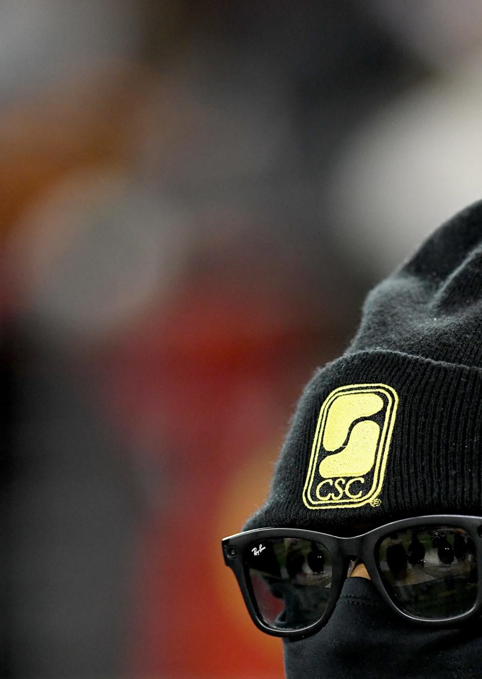 Marcus Jones of Cleveland, a supervisor on duty with CSC Security, covers up against the wind and cold at the OHSAA State Football Championships at Tom Benson Hall of Fame Stadium in Canton.