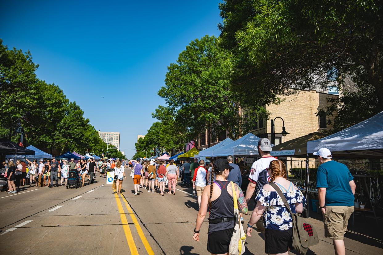 Attendees walking College Avenue during a 2023 Farm Market event