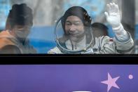 Japanese entrepreneur Yusaku Maezawa waves from a bus as he departs for his launch to the International Space Station (ISS) at the Baikonur Cosmodrome