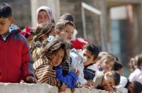 Children are picutred at a camp housing Syrian refugees who fled Hama province, on March 22, 2015 in the Lebanese southern city of Sidon