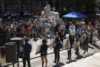 A group of writers and supporters gather in solidarity of support for author Salman Rushdie outside the New York Public Library, Friday, Aug. 19, 2022, in New York. (AP Photo/Yuki Iwamura)